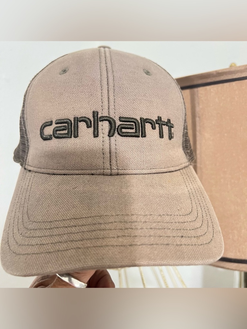 Carhartt canvas mesh-back trucker hat featuring embroidered brand logo on front